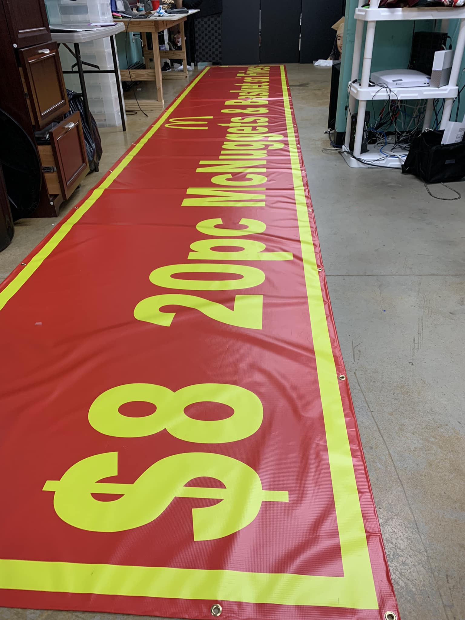 Vibrant custom banners displayed at an outdoor event, showcasing colorful graphics, logos, and promotional text for businesses and special occasions.