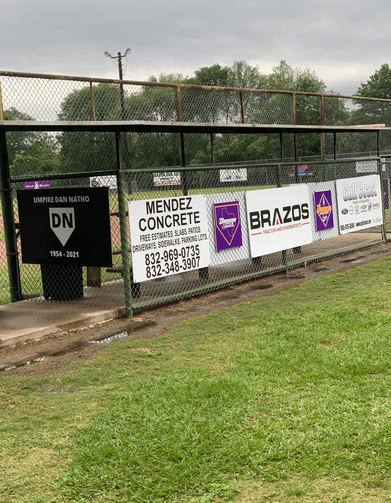 Custom Corrugated Plastic Signs on a fence being displayed 